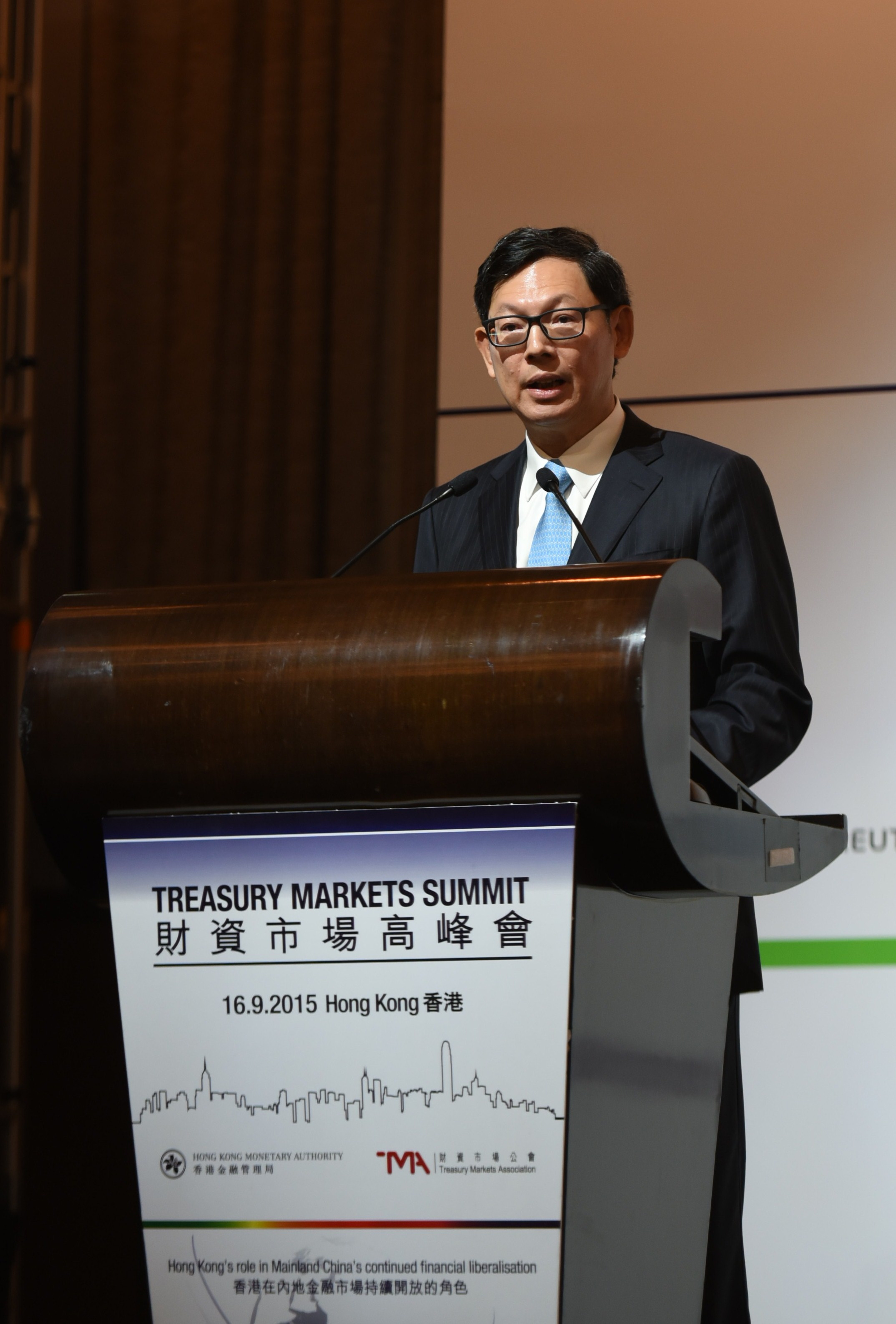 Mr Norman T.L. Chan, Chief Executive of the Hong Kong Monetary Authority, gives the keynote speech at the Treasury Markets Summit 2015 held in Hong Kong.