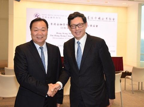  Mr Norman Chan, Chief Executive of the HKMA [right] greets Mr Yue Yi, Chairman of the HKCEA [left].