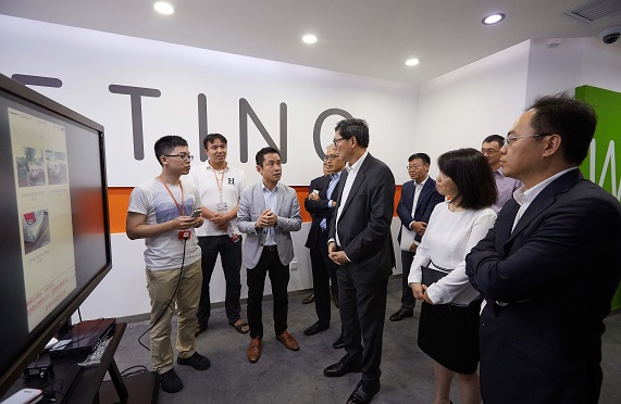 Mr Norman Chan and Mr He Xiaojun (first from right) visit Ping An Technology and meet with its Chief Executive Officer Mr Ericson Chan (third from left) to understand the research and development of innovative Fintech products.