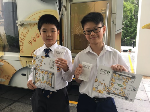 Students are happy to receive the “Coin Cart” paper craft as souvenir after exchanging their spare coins.