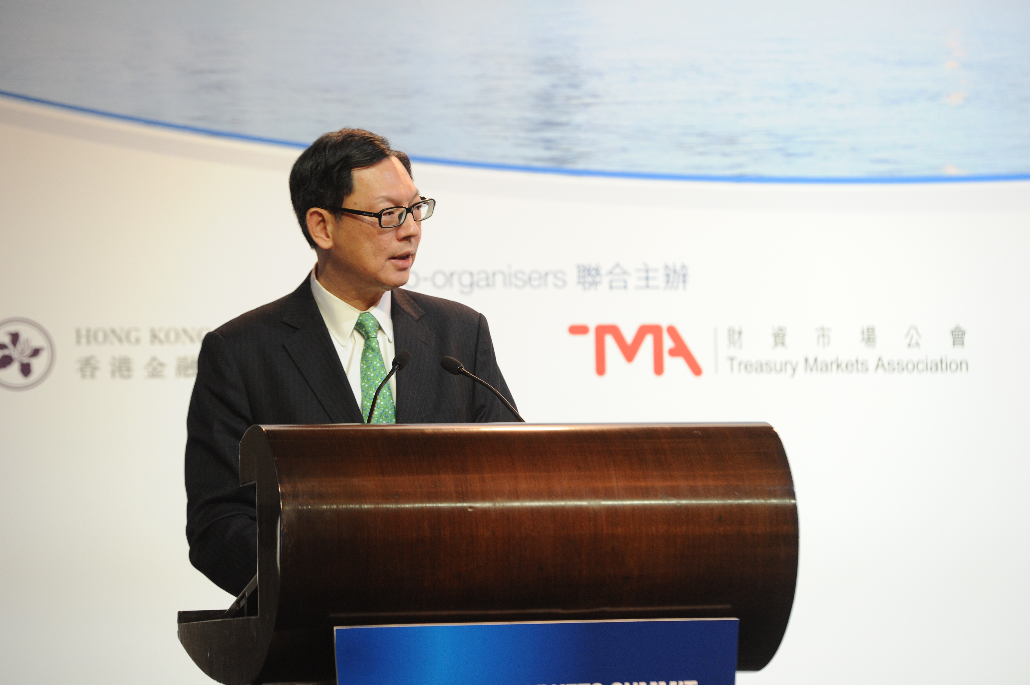 Mr Norman Chan, Chief Executive of the Hong Kong Monetary Authority, gives the keynote speech at the Treasury Markets Summit 2013 held in Hong Kong.
