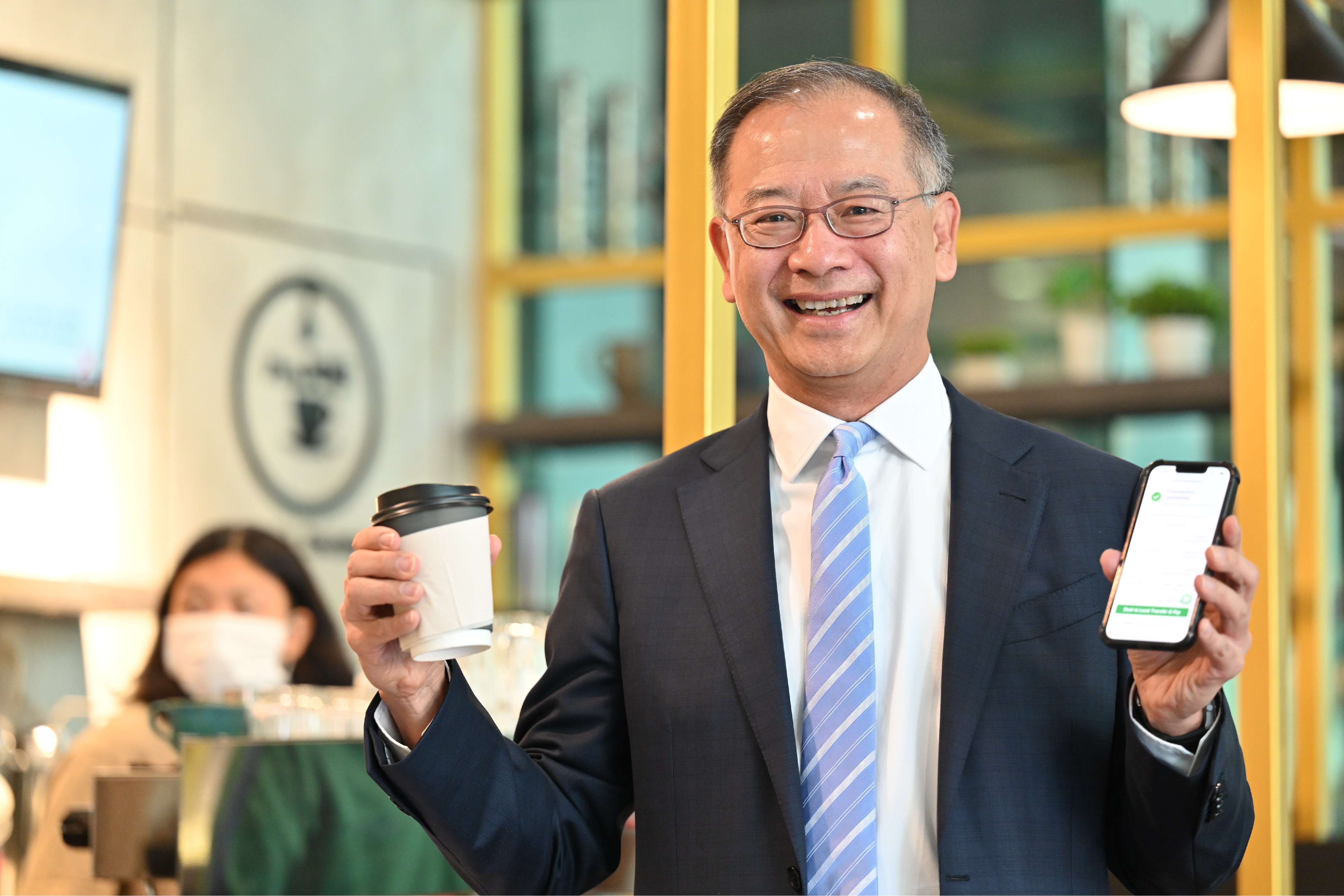 Mr Eddie Yue, Chief Executive of the Hong Kong Monetary Authority uses the Faster Payment System x PromptPay Link in a local café in Bangkok.