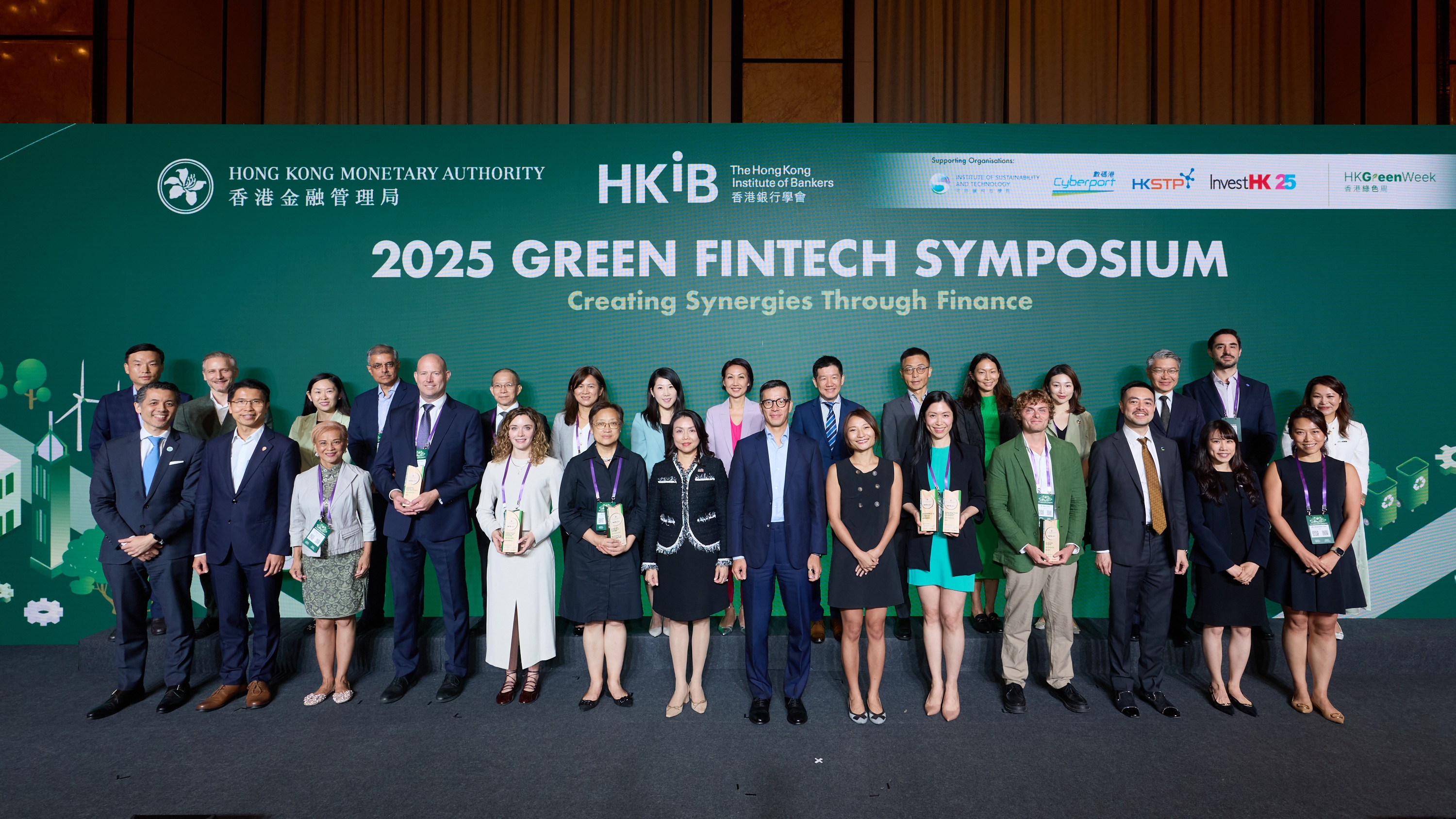 Mr Donald Chen, Executive Director (Banking Policy) of the Hong Kong Monetary Authority (front row, seventh from right), presents awards to the winners of the 2025 Green Fintech Competition with Ms Carrie Leung, Chief Executive Officer of the Hong Kong Institute of Bankers (front row, seventh from left); Ms Sonia Lau, Head of Program Management, Institute of Sustainability and Technology (front row, sixth from right); Mr Victor Yim, Head of FinTech, Hong Kong Cyberport Management Company Limited (front row, third from right); Mr Howard Lee, Associate Director, GreenTech, Hong Kong Science and Technology Parks Corporation (front row, second from left); and Ms Angel Fung, Senior Vice President, (Sustainability) for Financial Services and Fintech, Invest Hong Kong (front row, second from right).