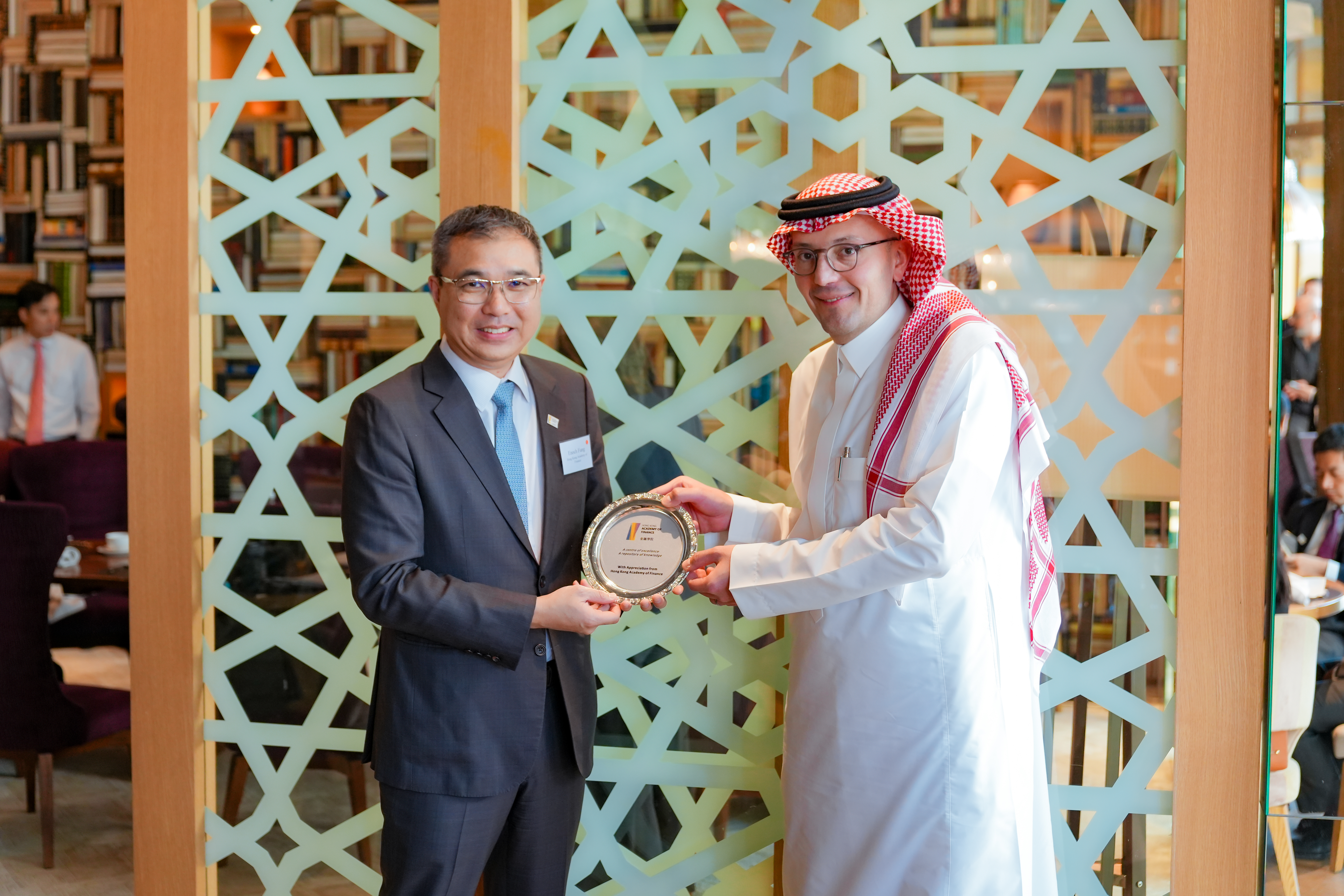 Presentation of souvenir at a luncheon hosted by Standard Chartered Bank connecting FLP participants with Chinese corporates operating in the Middle East region.